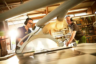 Šilingas dirba ant medinės lentos.